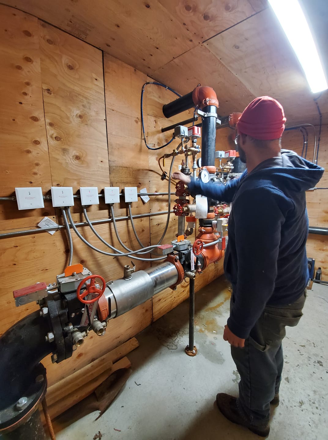 Kelco Electric technician wiring a panel and conduit on a job in Rhode Island